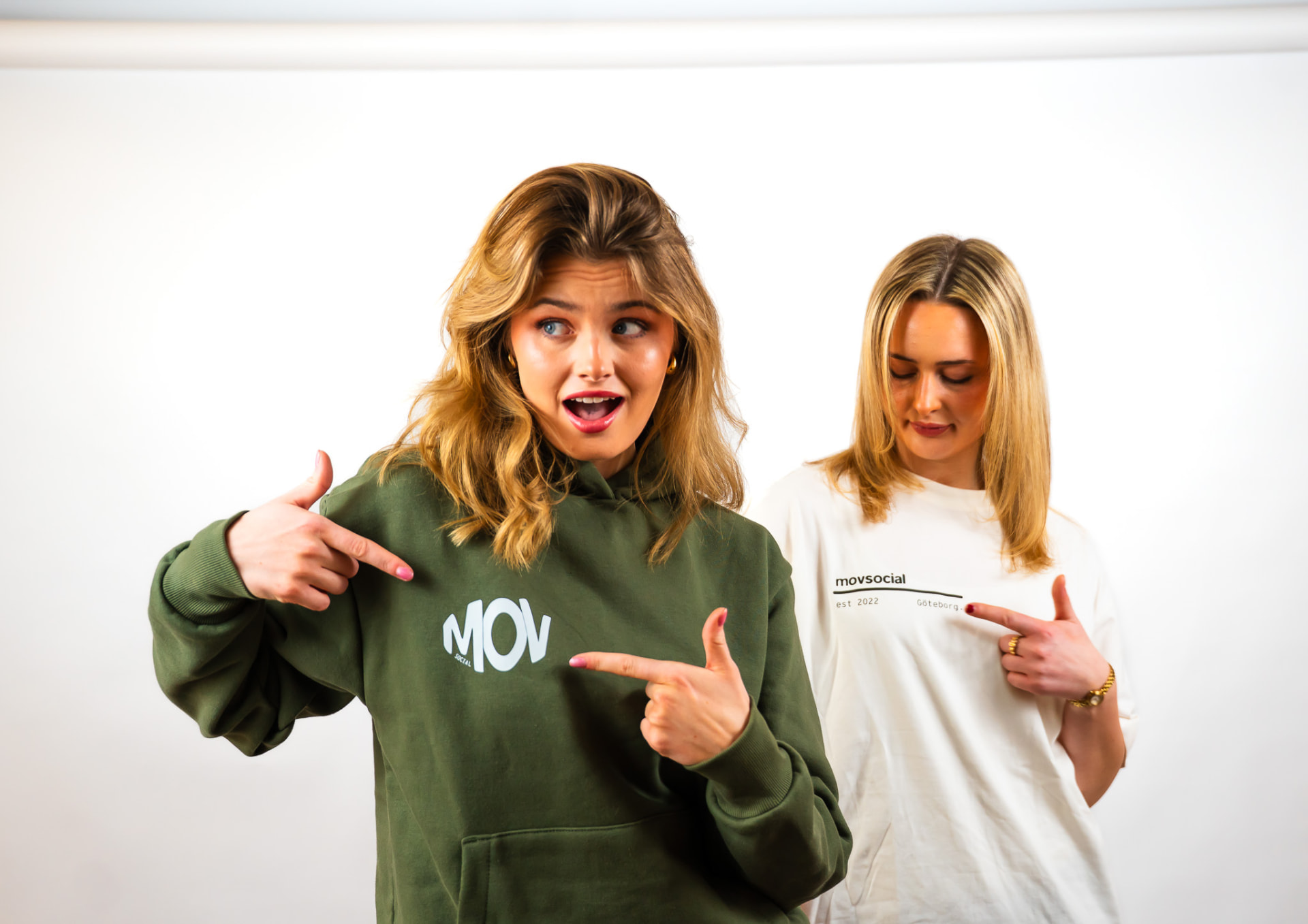 Movsocial olive hoodie front worn in the studio