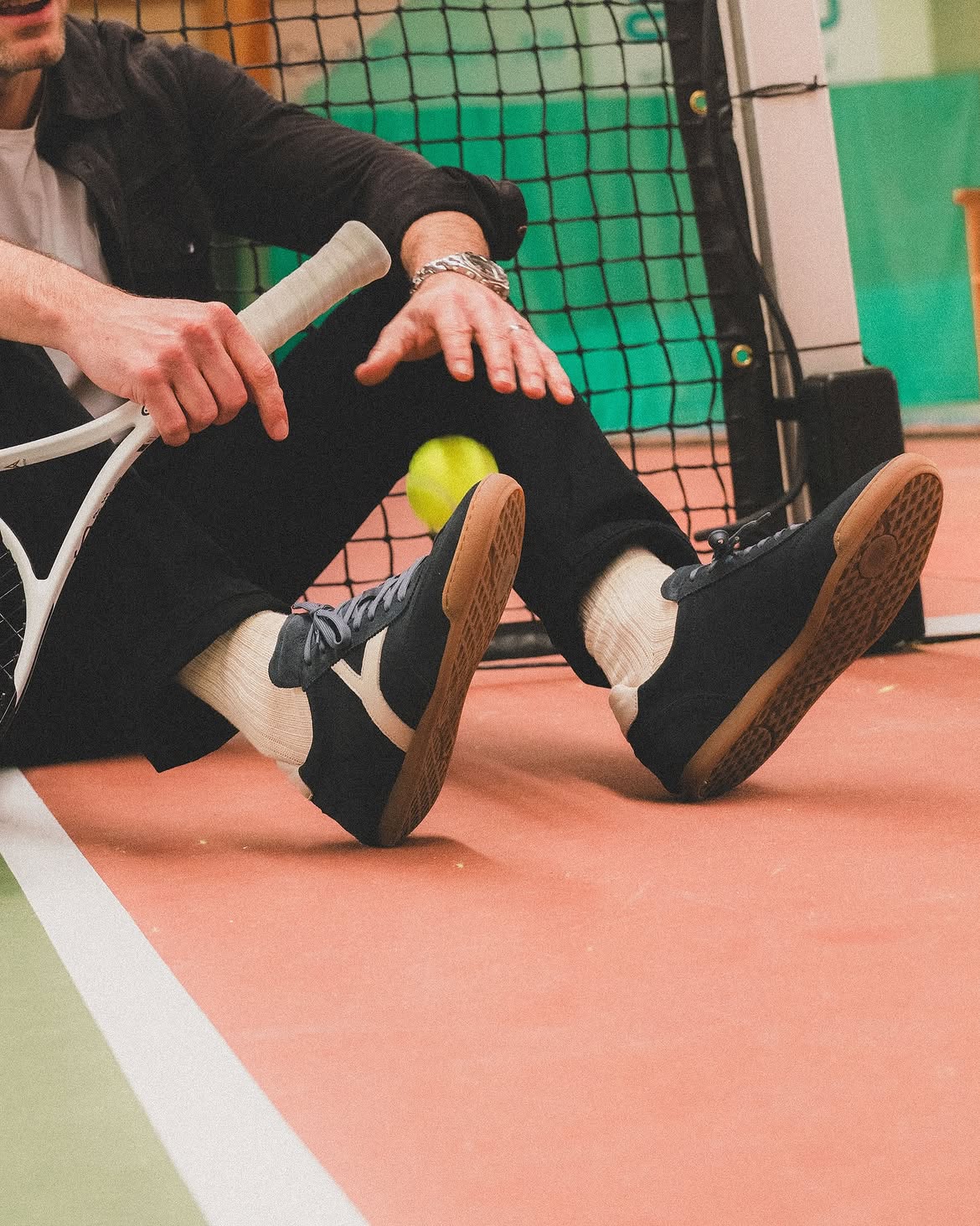 Sneaky Steve Milwaukee Slim sneakers on a tennis court