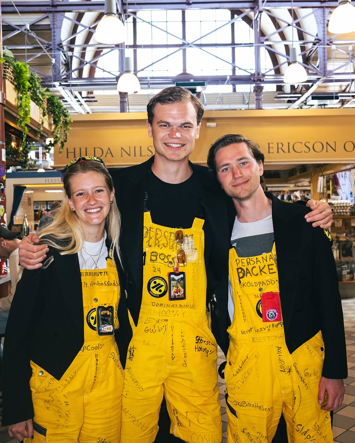 Three visitors celebrating Valborg inside Stora Saluhallen
